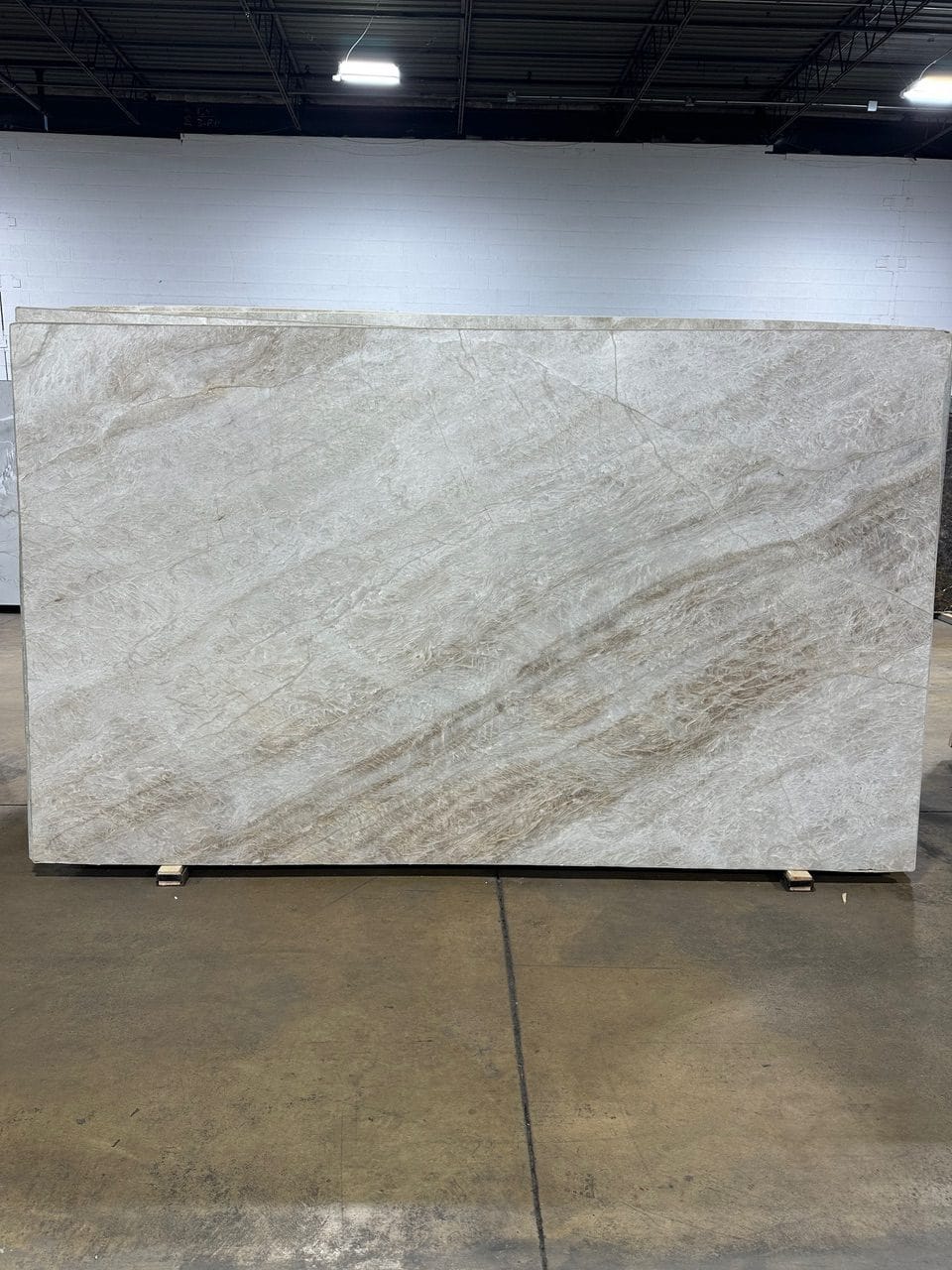 Perla Santana — beige-to-warm-cream ground with natural flowing movement.
